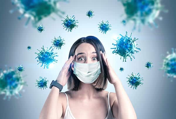 Woman wearing a surgical face mask avoiding germs for COVID-19 Anxiety and Work Life Balance | Online Counseling in London at YTherapy UK