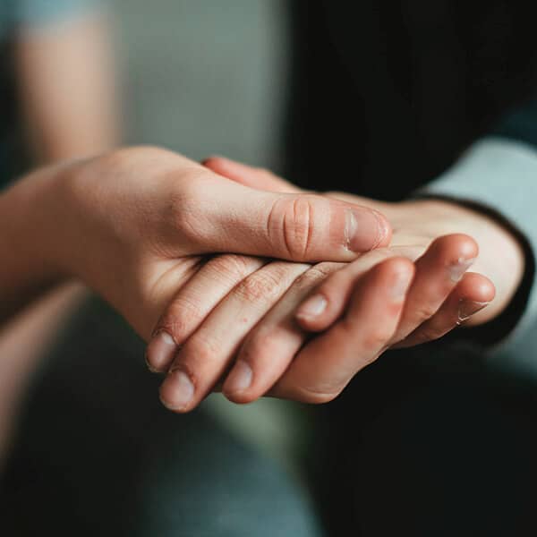 Helping hands showing care and support between two people. YTherapy offers mental health support and therapy for anxiety in London and online.